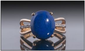 9ct Gold Dress Ring, Set With A Central Polished Lapis Lazuli Between Diamond Set Shoulders. Fully