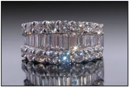 18ct White Gold Diamond Cluster Ring. Set With A Central Row Of Graduating Baguette Cut Diamonds