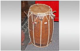 A Large Native Wood Drum, with encised ring design around the body, patched up with old metal work