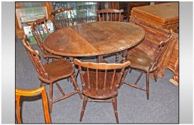 Early Twentieth Century Oak Drop Leaf Gateleg Table together with 6 associated chairs.