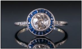 18ct Gold Art Deco Style Sapphire And Diamond Ring. Set with a central round modern brilliant cut