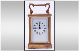 A 20th Century Brass Carriage Clock, Key wind, 8 day movement, white dial, black numerals, stands