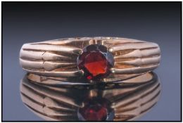 9ct Gold Gents Dress Ring, set with a small round garnet in a pierced setting. Fully hallmarked.