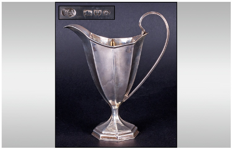 Silver Cream Jug Of Faceted Form, with moulded handle, raised on pedestal foot. Hallmarked for
