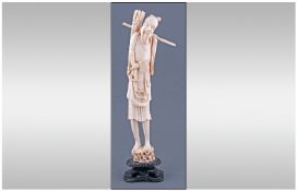 Japanese - Ivory Early 20th Century Figure of a 'Woodcutter'. Raised on an Ebony Plinth. Stands 11.5