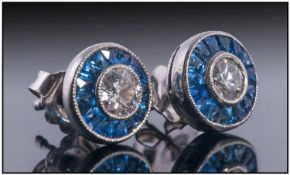 Art Deco Style Diamond And Sapphire Earrings. Central Diamond Surrounded By Calibre Cut Sapphires.