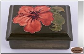 Moorcroft Lidded Rectangle Shaped Box, "Coral Hibiscus" design on green ground. Height 2 inches,