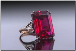 Continental Gem Set Ring, Set with a Large Ruby Coloured Emerald Cut Stone. Gallery Setting.