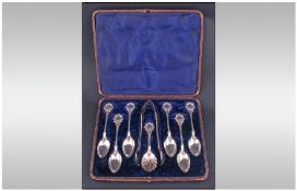 An Unusual Victorian Set Of Six Silver Spoons, Sugar Tongs And Caddy Spoon. Each handle decorated