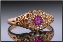 18ct Gold Diamond Dress Ring. Set with a central round ruby surrounded by rose cut diamonds in a