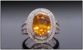 14ct White Gold Diamond Ring, Set With An Oval Cut Yellow Sapphire Surrounded By Two Rows Of