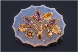 A Victorian Agate & Gold Brooch with three decorative flowers with cut Amethyst stones as flower