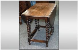 1930s Oak Barley Twist Leg Drop Leaf Table, oval shaped top terminating on cross stretchers. Top