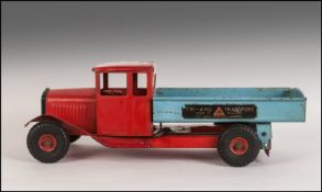 Triang Model Tipper Truck, painted red and blue. Label to side reads ' Triang Transport, Made in