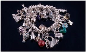 Silver Designer Charm Bracelet, Marked Milano Italy, Loaded With 28 Charms.