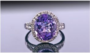 14ct White Gold Set Amethyst And Diamond Ring. The single oval cut amethyst surrounded by diamonds