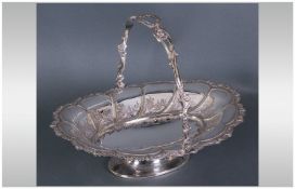 A Silver Plated Swing Handle Pedestal Fruit Basket, Circa 1950's. 11" in diameter, 3.25" in height.