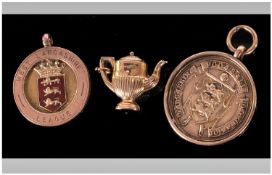 9ct Football Medals (2) Fully Hallmarked 1920s. Plus a 9ct Gold Charm in the Form of a Teapot. Fully