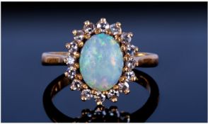Ladies 18ct Gold Set Opal And Diamond Set Cluster Ring. The central opal surrounded by 18 small