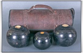 Set of Three Crown Green Bowls, in leather carry case.