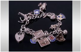 Silver Charm Bracelet. Loaded with 12 Charms, Complete With Padlock And Safety Chain.