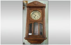 Early Twentieth Century Oak Cased Wall Clock, with Arabic Numerals and Brassed dial. With Pendulum