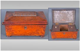 A Regency Mahogany Tea Caddy, with a Shaped top, Handles to the side, on Bun Feet. with a Fitted