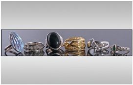 Collection Of Six Fashion Rings, Mostly Silver. Various Sizes And Designs.
