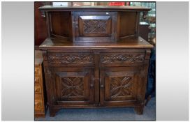 1930's Oak Court Cupboard, with carved cupboards and draws along with a carved super structure.