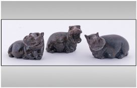 Set of Three African Carved Hippopotami, each in a crouching position, carved in soft or