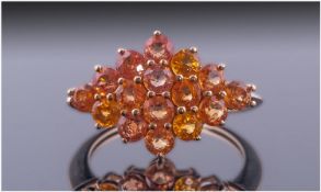 Yellow Sapphire Lozenge Shaped Cluster Ring, comprising sixteen round cut deep yellow sapphires in a