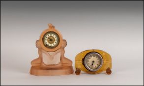 Art Deco Mouled Pink Glass Figural Clock, the case adorned with semi-clad women and standing 7" in