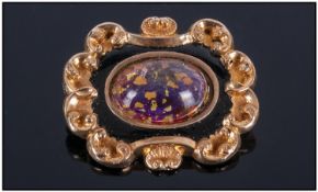 19th Century Gilt Metal Morning Brooch. shape moulded form with central glazed front surrounded by
