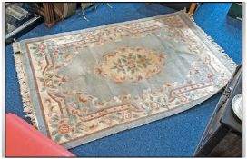 Large Room Size Wool Rug. Pink decoration on predominantly light green ground. Fringed edges. 12