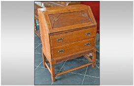 Small 1930's Oak Bureau on two long drawers, square legs and cross stretchers. Fitted interior.