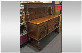 1930's Oak Mock Jacobean Sideboard. With back two central drawers, brass handles and flanked by