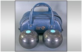 Two 'Thomas Taylor' Crown Green Bowls and holdall.