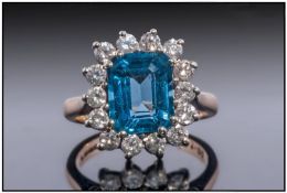 9ct Gold Dress Ring, Set With A Large Central Blue Topaz Surrounded By 14 Round Brilliant Cut