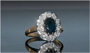 18ct Gold Set Ladies Diamond And Sapphire Cluster Ring, The Central Sapphire, surrounded by 12 small