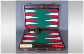 A Modern Italian Backgamon Game, in brown leatherette case. Hardly used condition. Complete with
