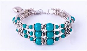 Turquoise Triple Row Cuff Bangle comprising several sizes of round turquoise beads with decorative