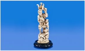 A Fine Carved Late 19th Century Japanese Ivory Figure. Elf figures, Omi with lady holding a fan.