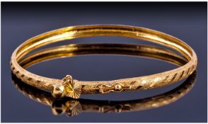 Indian Gold Bangle, With Textured Design and Single Bell Charm. Unmarked Tests 22ct. Weight 3.8