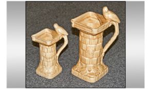 Two Wade Art Deco Jugs In The Form Of Towers, each with a bird figure surmounted to top. Marked to