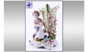 A Dresden Type Figural Vase depicting a putti with a swan with a cornucopia shaped vase at the side.
