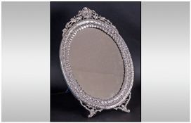 A Fine Quality Large Oval Shaped and Ornate Eyptian Silver / White Metal Dressing Table Mirror, with