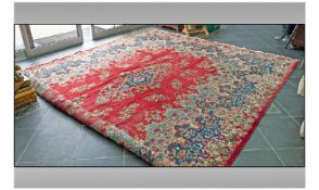 Large Floral Persian Carpet, size 12 foot by 10 foot. With a central medallion in ruby red, bordered
