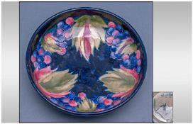 William Moorcroft Signed Footed Bowl. Leaves and black berries on blue ground. Circa 1928-1935.