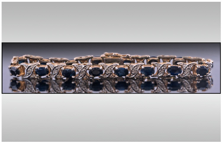 Silver Gilt Line Bracelet set with faceted dark blue stones.