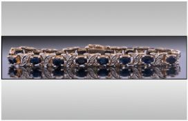 Silver Gilt Line Bracelet set with faceted dark blue stones.